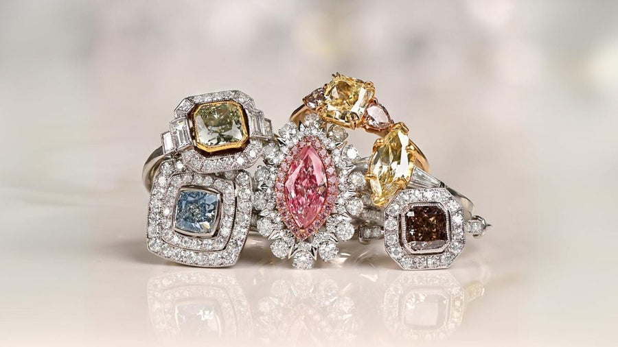 Collection of fancy color lab grown diamond engagement rings — yellow, pink, blue, and green