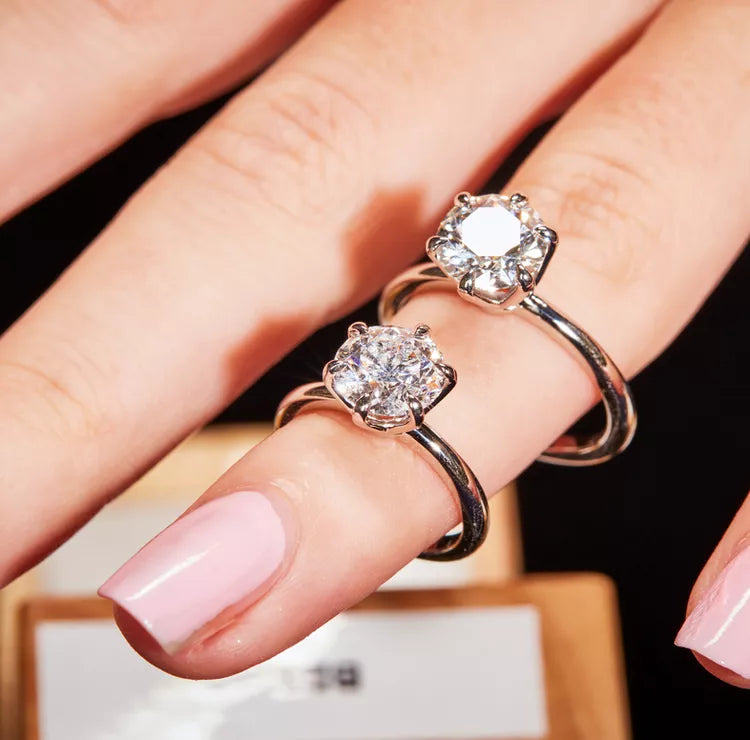 Bride and groom selecting a lab grown diamond engagement ring from a tray of options