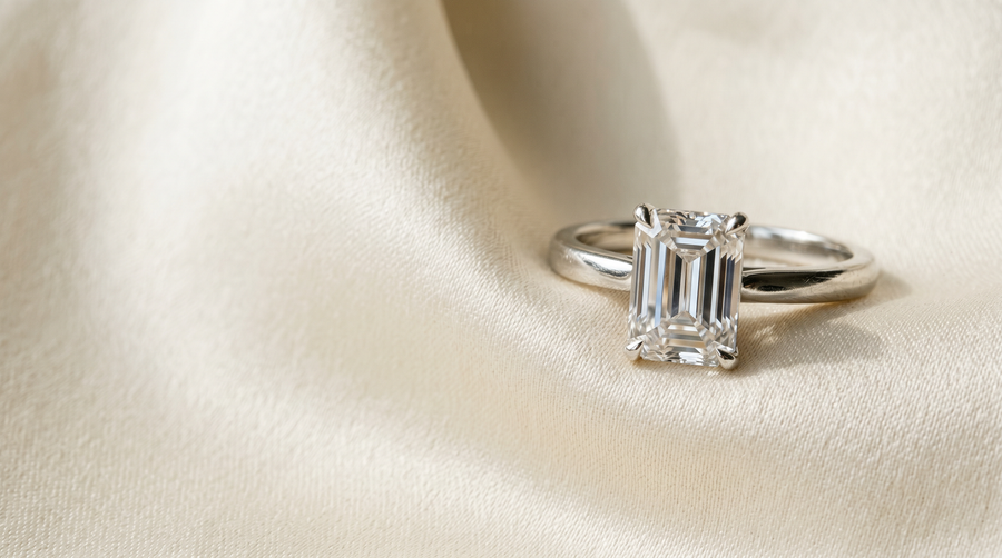 Emerald cut lab grown diamond engagement ring in platinum solitaire on cream silk — Mohana Jewels